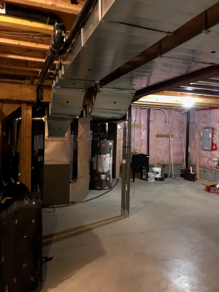 Exposed basement structure and mechanical systems ready for inspection and maintenance