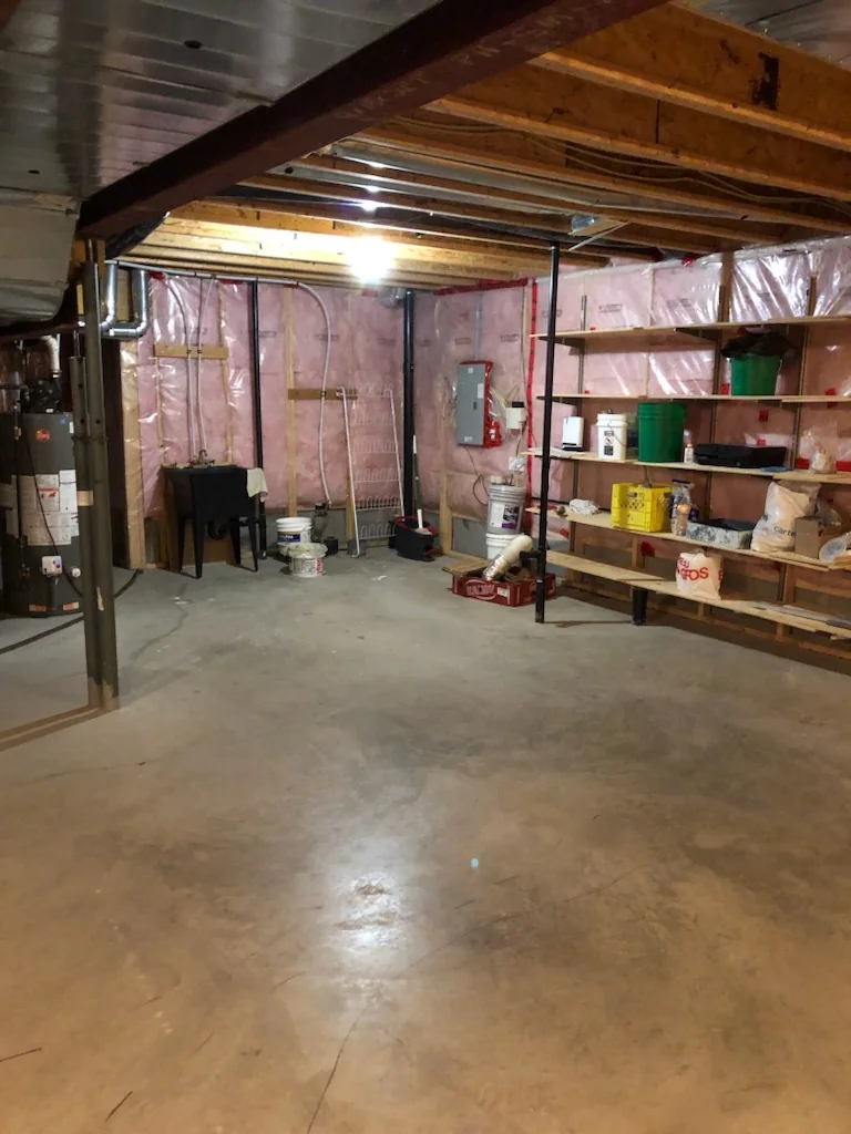 Open unfinished basement with exposed ceiling and concrete floor