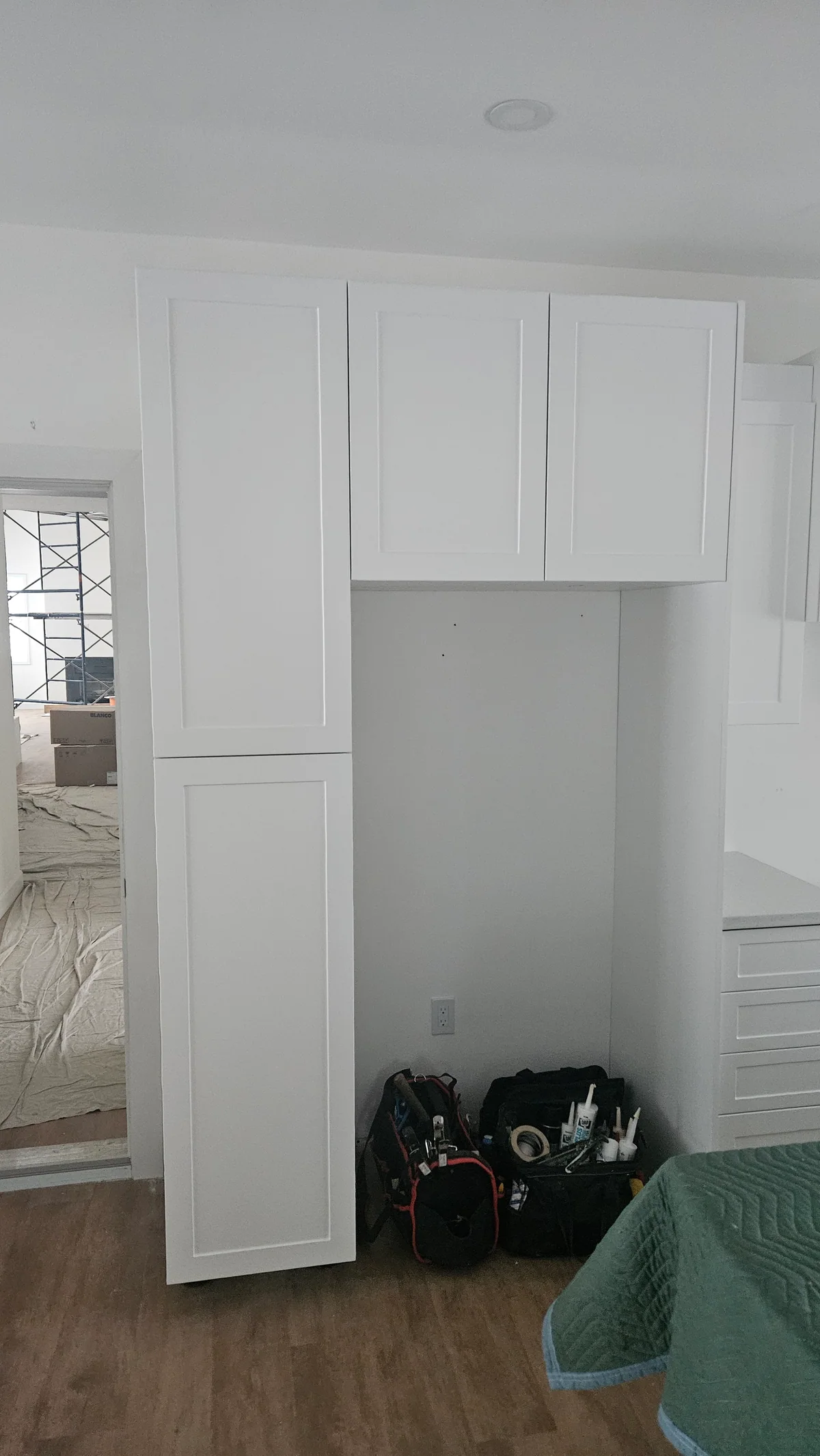 Floor-to-ceiling white cabinetry fitted around an interior doorway
