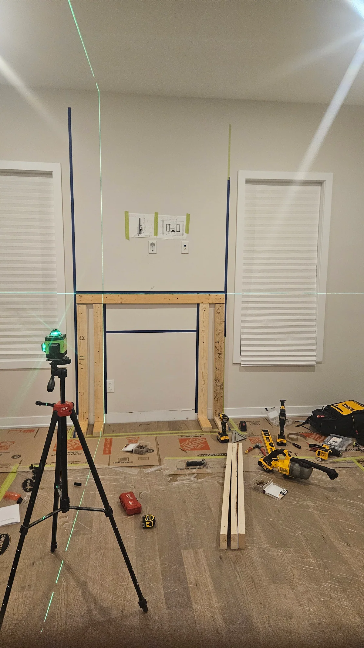 Framed fireplace opening under construction with installation tools nearby