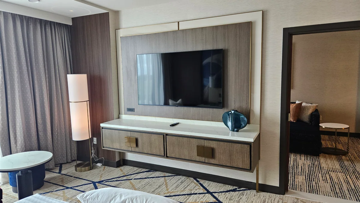 Custom television wall and storage console in a contemporary hotel suite