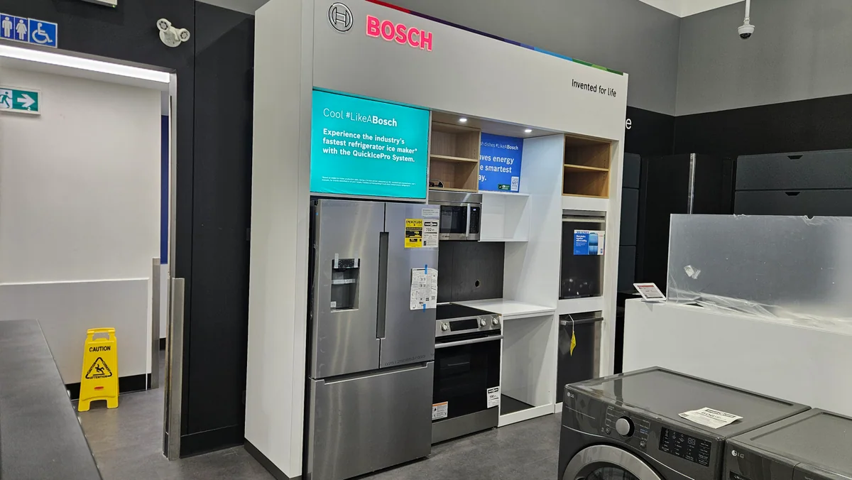 Bosch appliance display beside a grey work island in the finished showroom